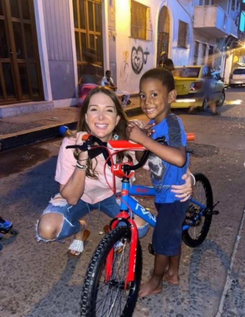 Bettina hace feliz a un niño al obsequiarle una bicicleta