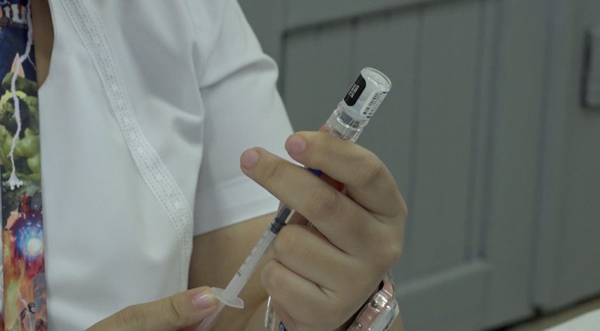 Enfermera sostiene un vial de la vacuna contra covid-19.