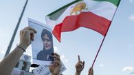 La bandera de Irán ondea junto a una foto de la joven Mahsa Amini. La bandera de Irán ondea junto a una foto de la joven Mahsa Amini.