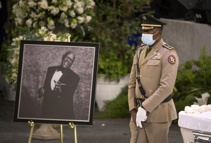 Un militar monta guardia de honor junto a un retrato del merenguero dominicano Johnny Ventura.