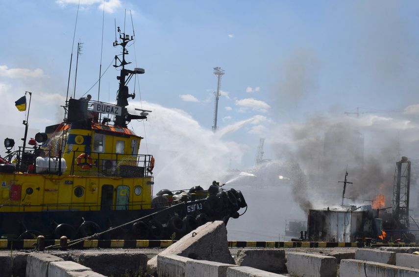 Bomberos ucranianos luchando contra un incendio en un barco que ardía en el puerto de Odesa después de que los misiles impactaran en el puerto.