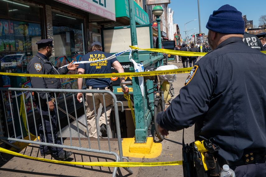 Miembros de la policía de Nueva York se reúnen en el lugar de un tiroteo en la estación de metro.
