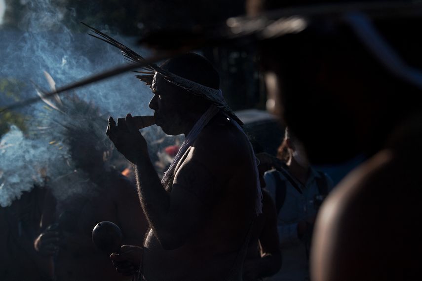 Un hombre de la tribu Kambiwa de Pernambuco fuma una pipa durante un ritual tradicional en un campamento de protesta indígena.