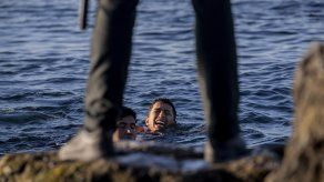 Migrantes agotados tras nadar en las aguas del Mediterráneo desde el país vecino.