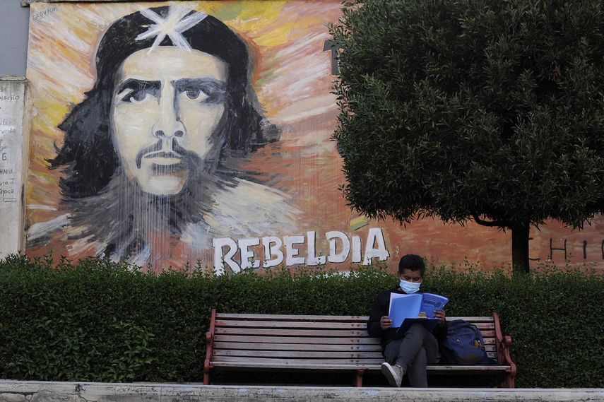 Un estudiante lee en una banca de la Universidad Mayor de San Andrés (UMSA)